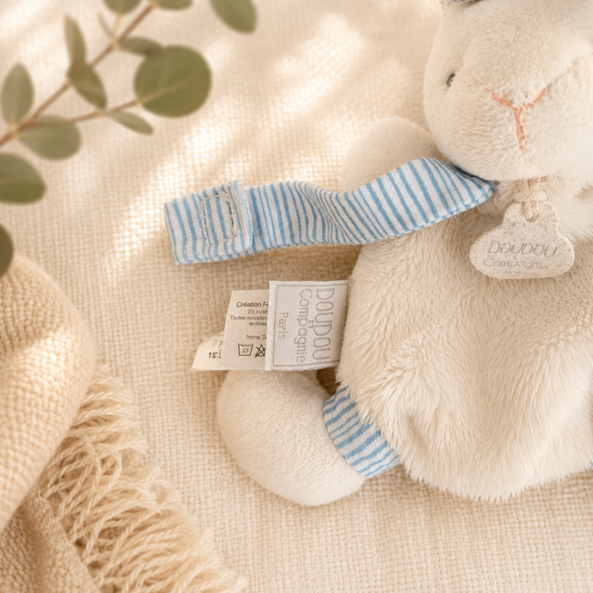 Étiquette Doudou et Compagnie sur doudou lapin blanc et bleu pour bébé