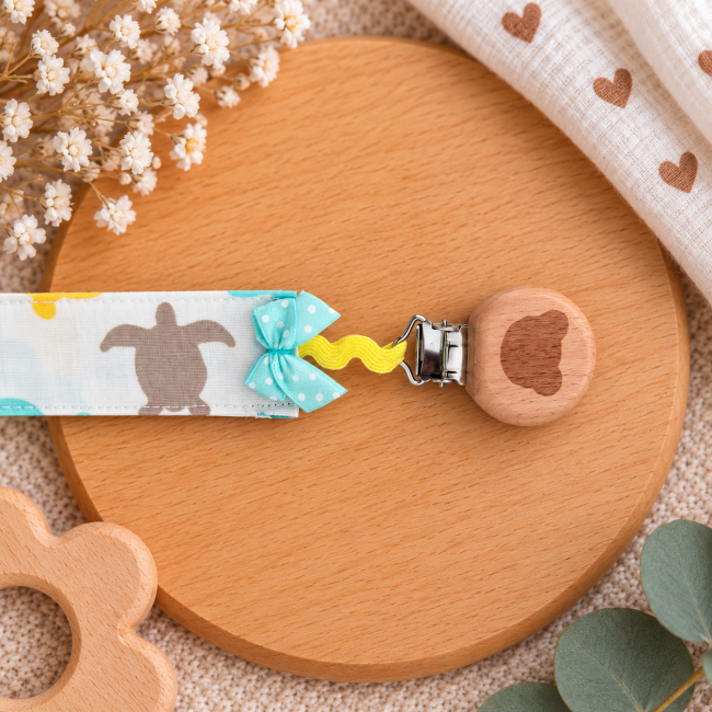 Détail du clip en bois naturel de l'attache sucette artisanale