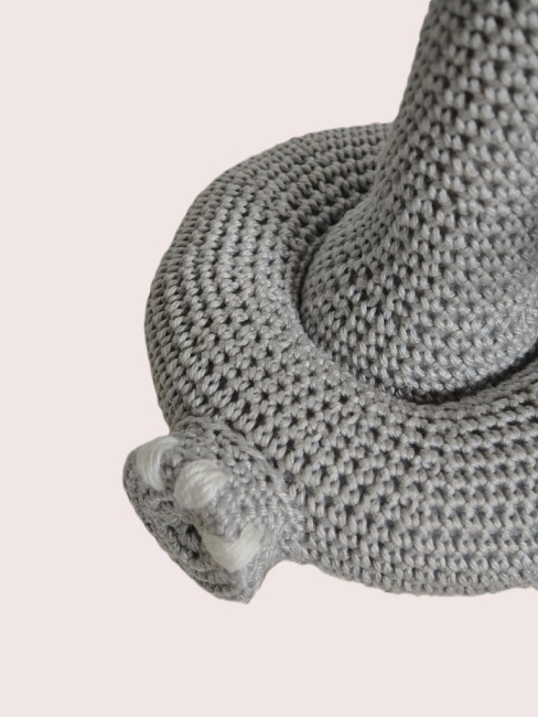 Gros plan sur les pieds et la base du jouet éléphant au crochet, montrant les mailles et finitions.