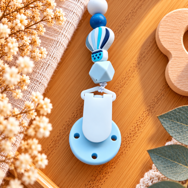Dos de la pince blanche et bleue Dos de l’attache sucette avec pince blanche à trois trous et perles silicone bleues et blanches