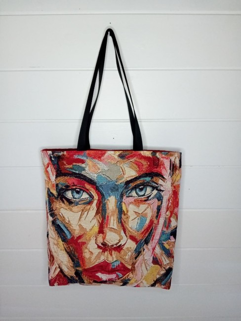 Cabas artisanal « Portrait coloré » avec motif de visage féminin multicolore et anses noires