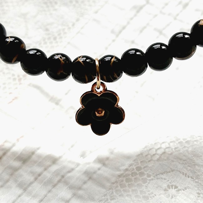 collier ras du cou perles noires et breloque fleur émaillée dorée