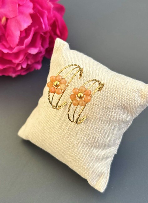 Boucles d'oreilles fantaisie composées d'une créole de 3 anneaux martelés en acier inoxydable doré et réhaussé par une jolie fleur en pierre naturelle de cornaline couleur corail pour un style bohème chic