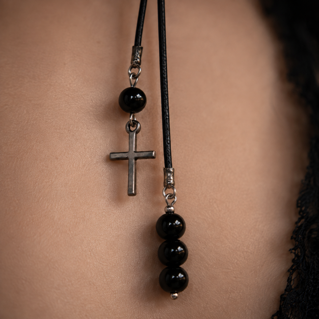 L’Orbe des Enchanteresses – Croix et perles d’obsidienne noire Détail de la croix argentée et de l’enfilade de perles en obsidienne noire du tour de cou gothique