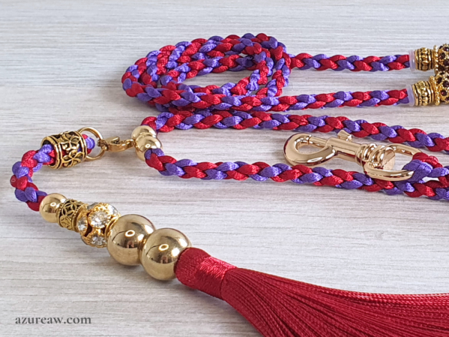 Laisse tressée rouge et violet avec perles, finitions dorées et pompon rouge amovible