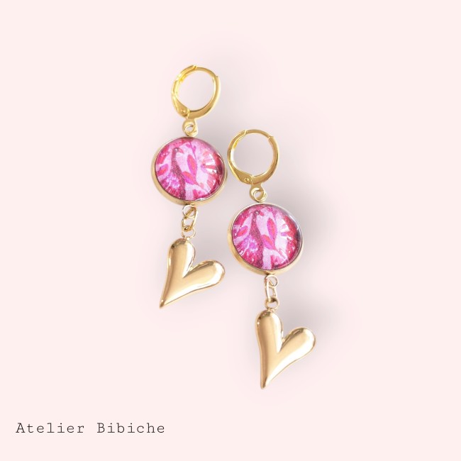 B.O. Dormeuses Cœur Doré & Cabochon Rose Floral - Atelier Bibiche Boucles d'oreilles pendantes à dormeuses dorées avec cabochon rond motif floral rose et cœur plein en métal doré brillant.