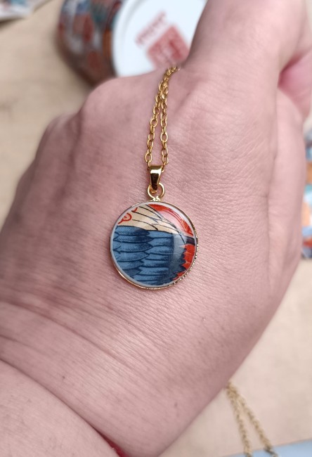 Collier Imari présenté en main pour visualiser le pendentif de 18 mm créé dans une ancienne théière japonaise.