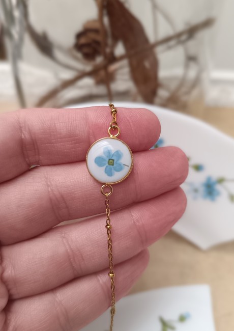 Détail du bracelet Myosotis, assiette Arcopal transformée en bijou fleuri.