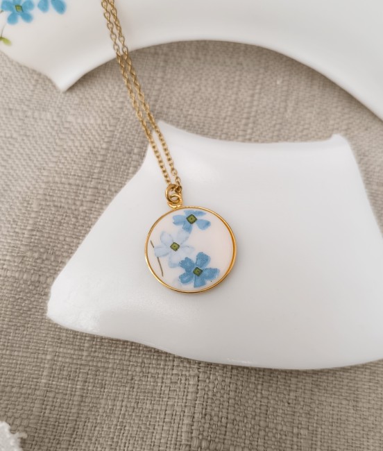 Collier Myosotis vu sur fond blanc, fragment d’assiette Arcopal transformé.