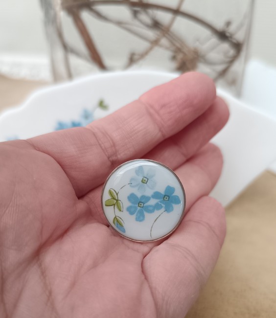 Bague Myosotis portée, bijou grand format lumineux et moderne en verre opalin.