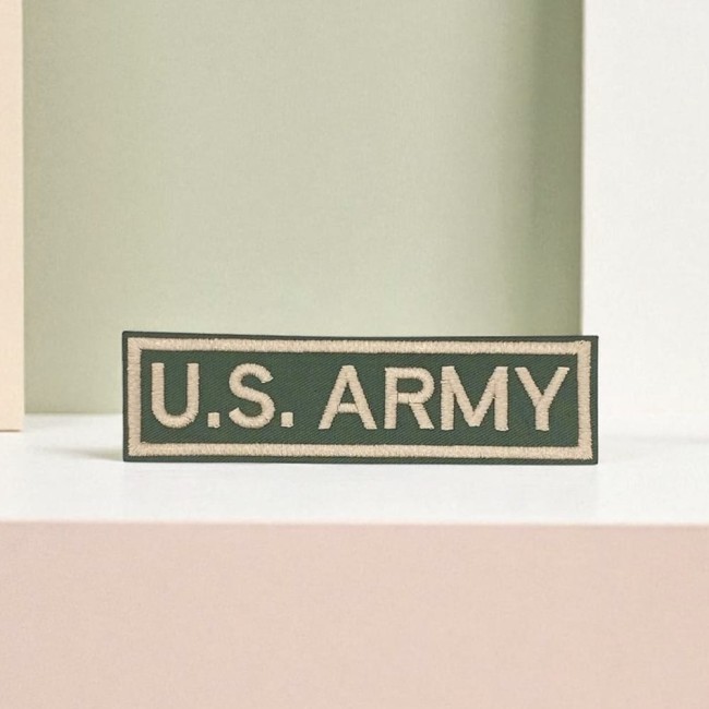 Patch brodé US ARMY noir avec bordures assorties sur tissu kaki 