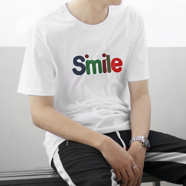 Écusson SMILE posé sur un t-shirt blanc