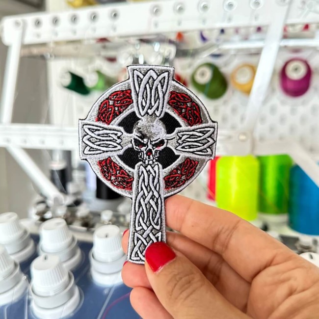 Gros plan sur broderie rouge de croix celtique
