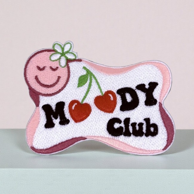 Écusson Moody Club brodé Patch brodé Moody Club présenté sur un support rond vert pastel