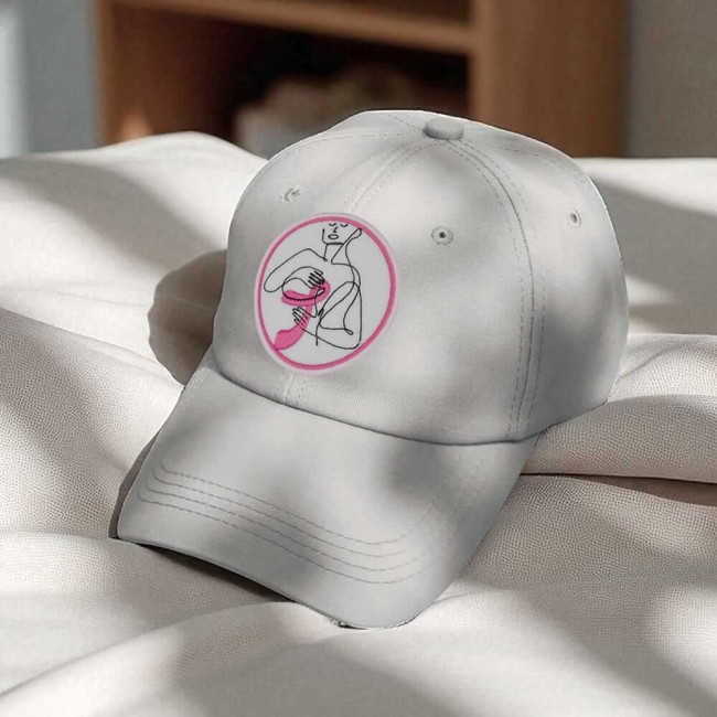 Patch brodé ruban rose sur une casquette blanche, symbole d’Octobre Rose 