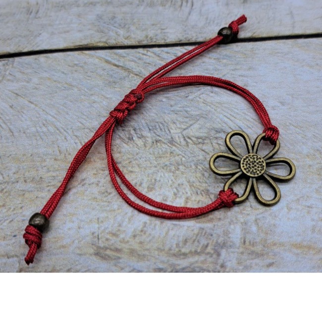 Bracelet ajustable en nylon avec connecteur fleur en métal bronze. Bracelet ajustable en nylon avec connecteur fleur en métal bronze.